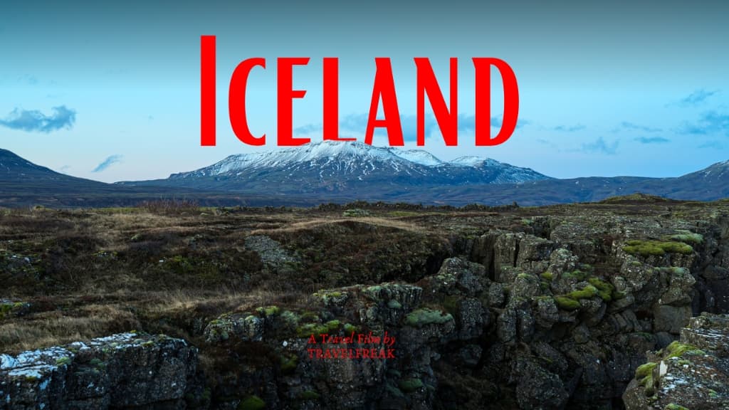 Ancient mossy lava fissure looking toward snow-capped volcanic peaks in Iceland