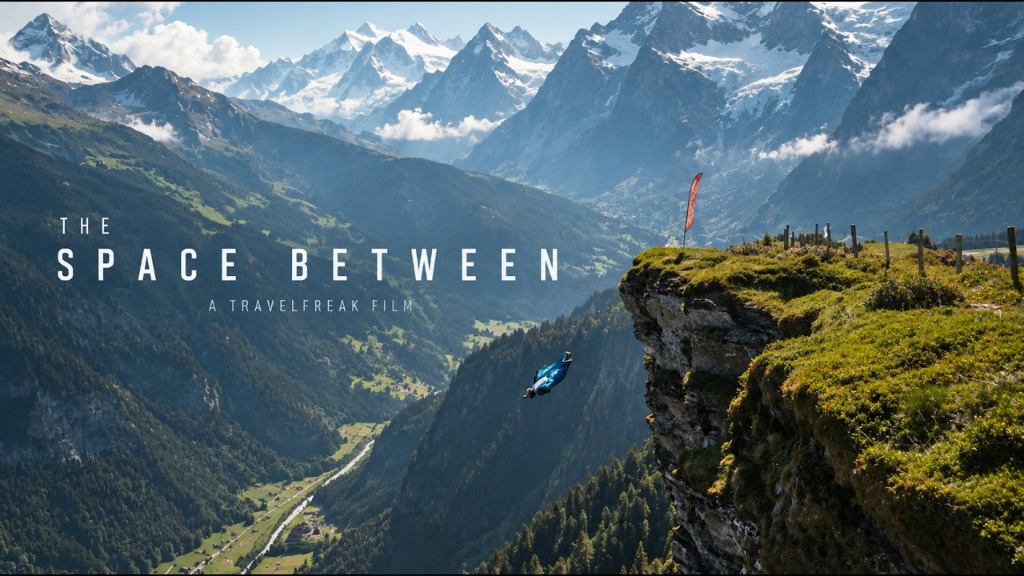 Wingsuit flyer diving off a towering alpine cliff in Switzerland overlooking the Lauterbrunnen valley