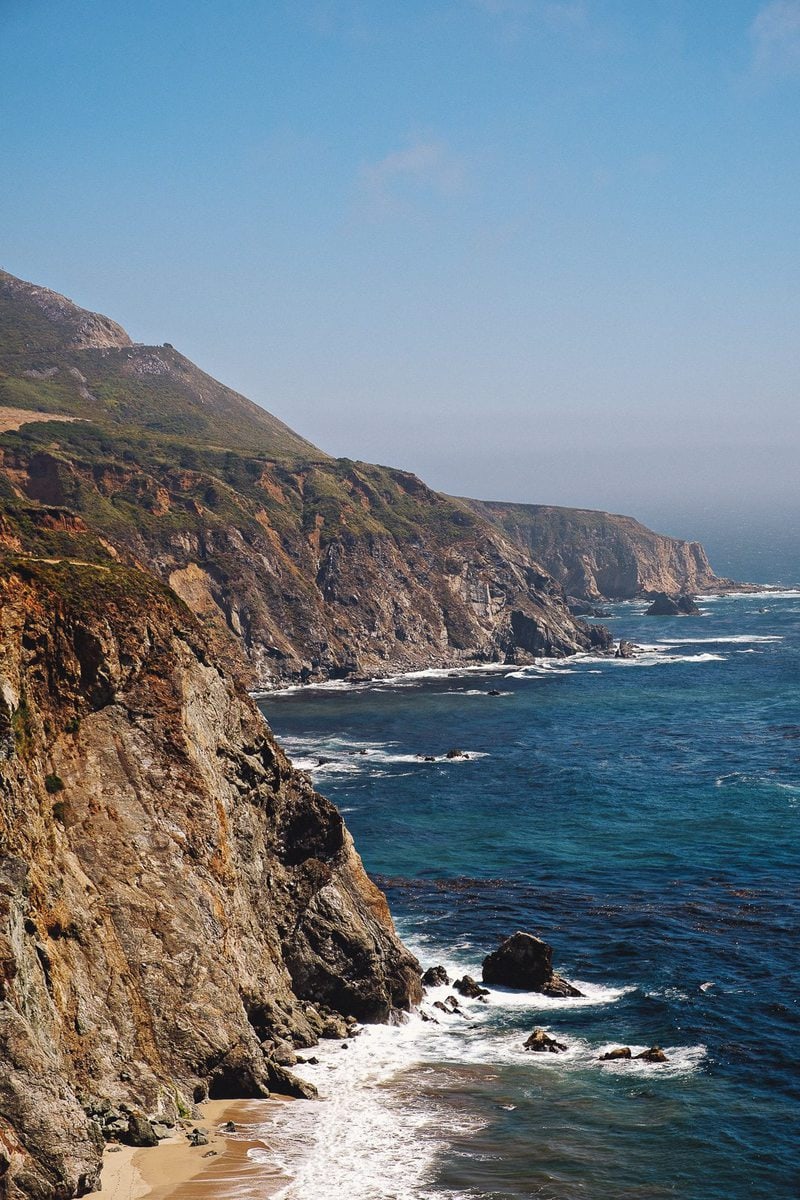 The sawtoothed California coastline at Big Sur, an essential stop on a Pacific Coast Highway road trip