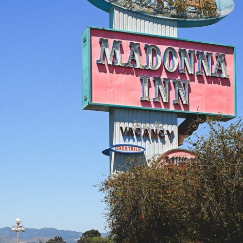 Dwarfed by the roadside sign for The Madonna Inn on the Pacific Coast Highway