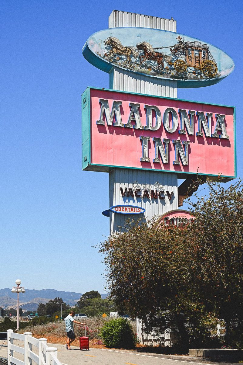 Dwarfed by the roadside sign for The Madonna Inn on the Pacific Coast Highway