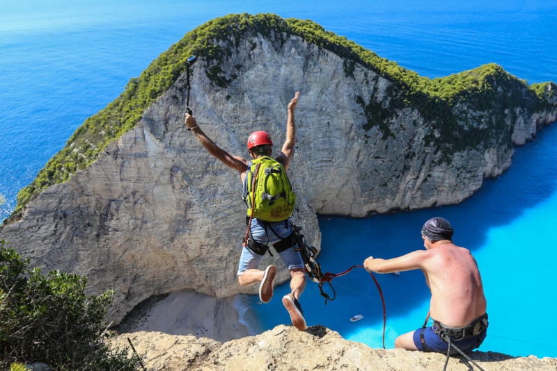Rope jumping from the top of Navagio Beach