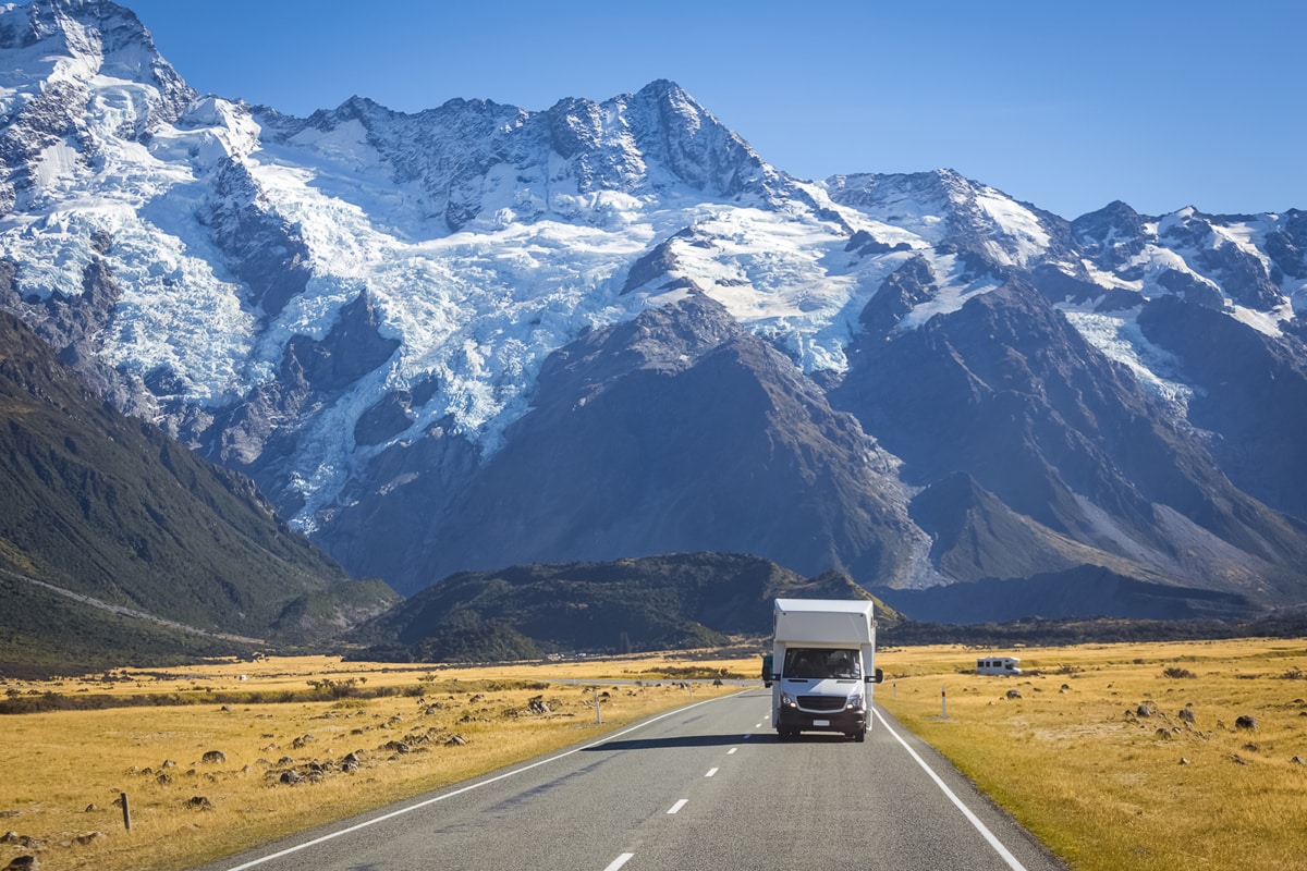a rented RV driving through the snow capped mountains