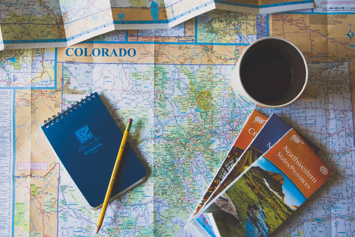 a map with a cup of coffee and travel planning tools