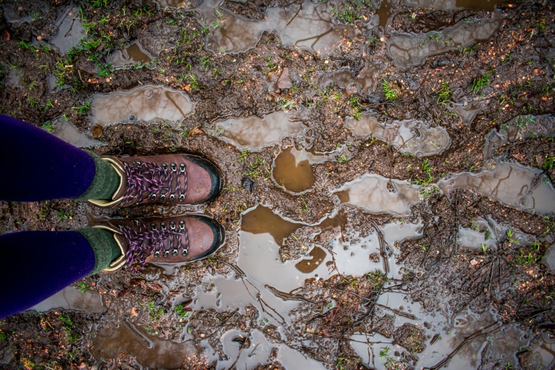 a woman's hiking boots in the mud