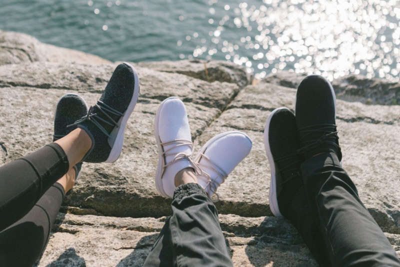 Three pairs of Vessi Everyday Shoes in front of the water