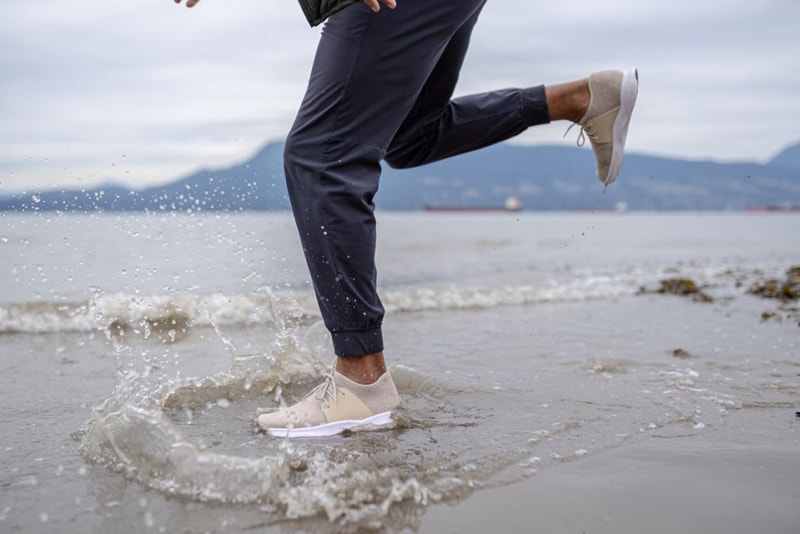 A person dancing through the water in their Vessi shoes