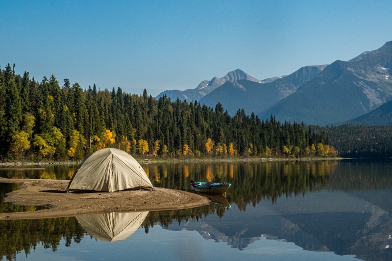 A tent on a beach in front of the mountains