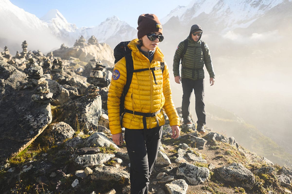 Two people wearing Mountain Hardwear jackets in the mountains